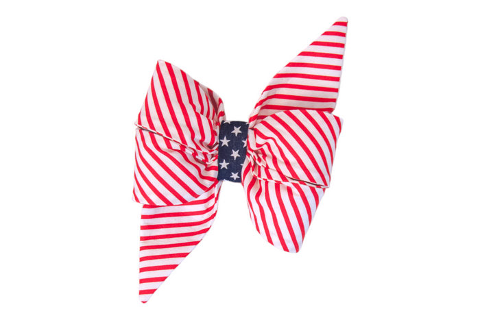 Let your furry friend join in on the patriotic celebrations! This bold and stylish girl dog belle bow is designed to reflect the spirit of American pride. With vibrant red and white stripes flanking a navy blue center adorned with white stars, this bow tie is perfect for Independence Day, Memorial Day, Veteran's Day, and any day you want to showcase your love for the USA.