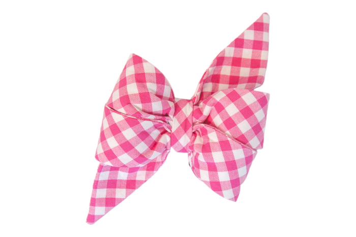 Vibrant fuchsia plaid dog belle bow with a white check pattern, crafted into a feminine voluminous double-layered bow. Long, sharply tapered ends extend from the knot, adding a playful yet polished flair.