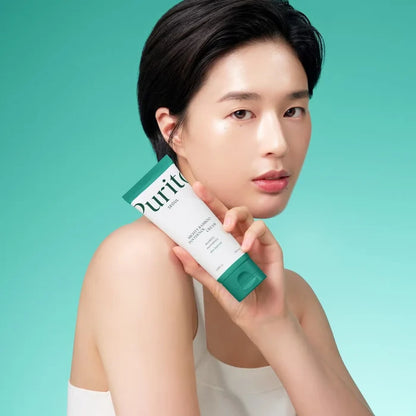 Woman holding a Purito skincare product against a teal background