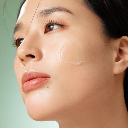 Close-up of a woman's face with a green background