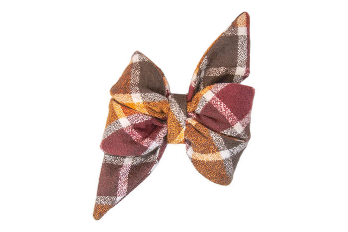 Fall-themed flannel belle bow featuring a bold tartan pattern in rich hues, cinched at the center with puffed loops and sharply tapered ends, giving it a feminine look.